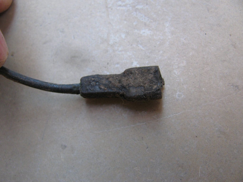 Female spade terminal with black plastic insulation.